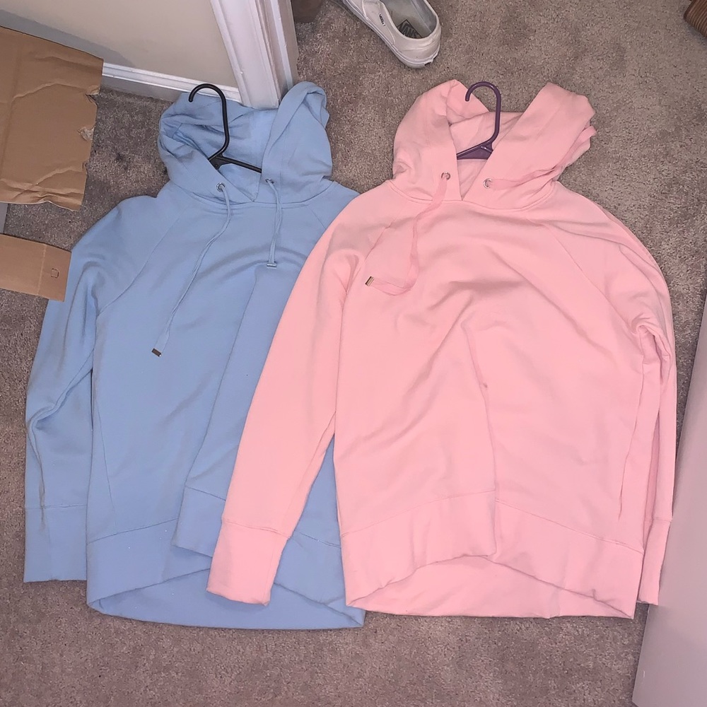 2 pink and blue hoodies